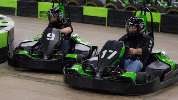 Two karting racers are racing on the track